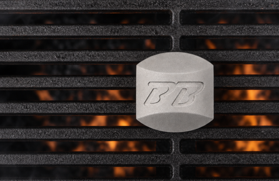 Boss Briquette on a grill grate over flames